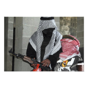 A role-playing enemy aggressor arms a dummy photo print