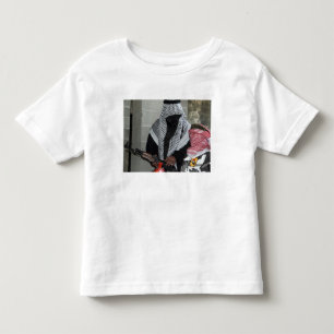 A role-playing enemy aggressor arms a dummy toddler t-shirt