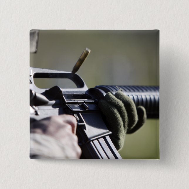 A round flies from the chamber of an M-16A2 2 Inch Square Button (Front)