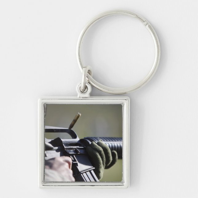 A round flies from the chamber of an M-16A2 Keychain (Front)