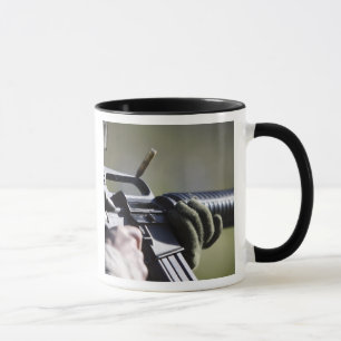 A round flies from the chamber of an M-16A2 Mug