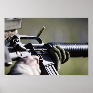 A round flies from the chamber of an M-16A2 Poster