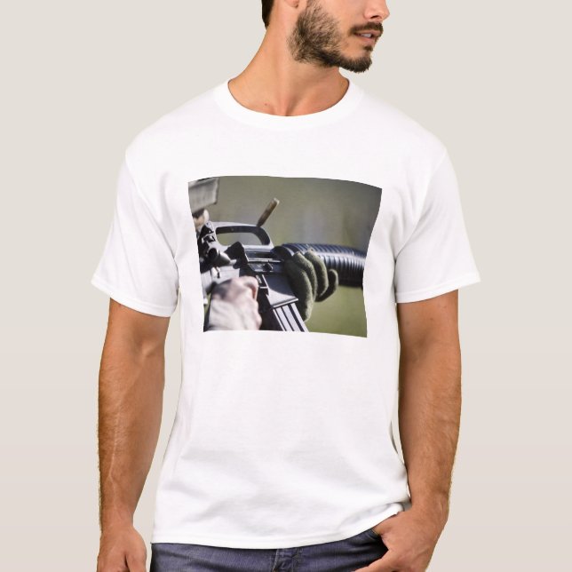 A round flies from the chamber of an M-16A2 T-Shirt (Front)