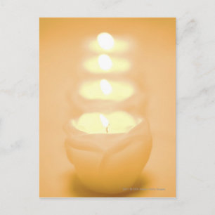 A row of lit candles postcard