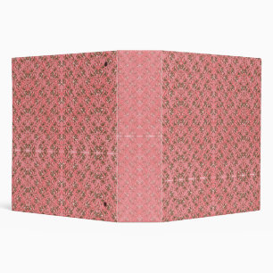 A rug with a red and pink motif features a decorat binder