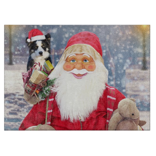 A santa claus holding a cute Border Collie and chr Cutting Board (Front)