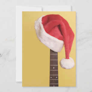 A Santa hat hangs on an acoustic guitar Holiday Card