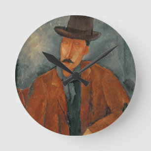 A seated man leaning on a table round clock