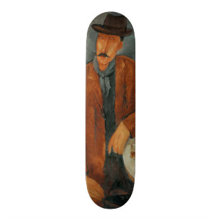 A seated man leaning on a table skateboard