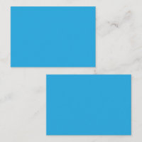 A serene blue sky with a few scattered white cloud