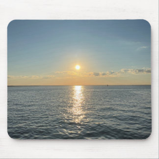 A serene sunset over a calm water horizon mouse pad