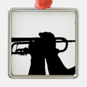 A service member plays a tune metal ornament