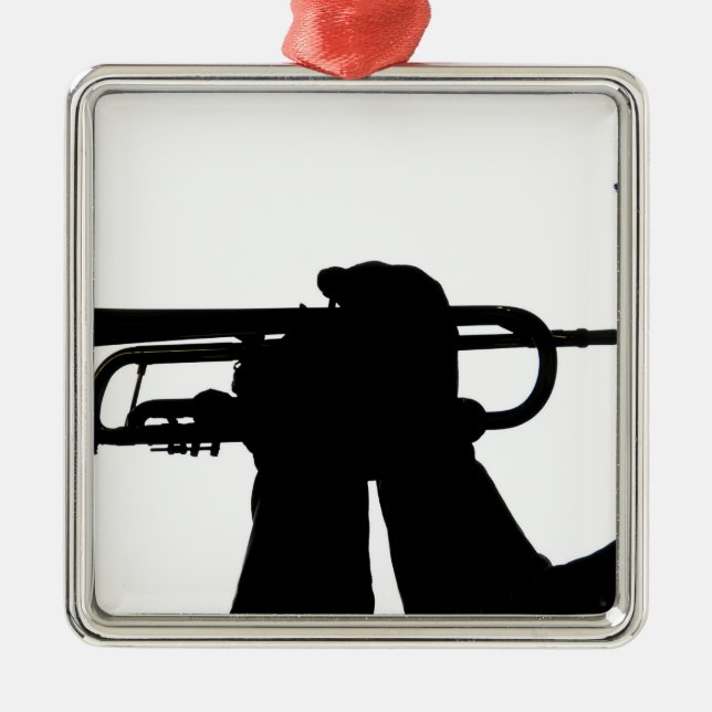 A service member plays a tune metal ornament (Front)