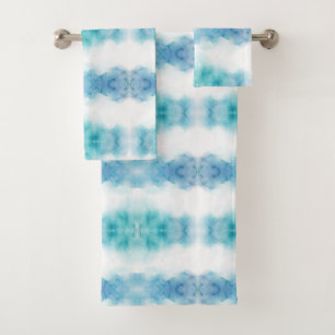 A set of three towels on a rod, featuring a blue