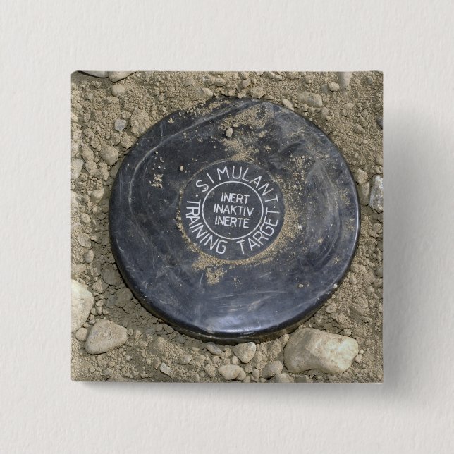 A simulated land mine 2 inch square button (Front)