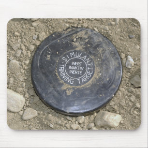 A simulated land mine mouse pad