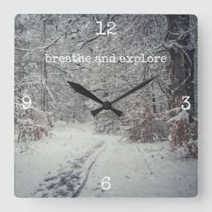 A snow-covered path through a winter forest square wall clock