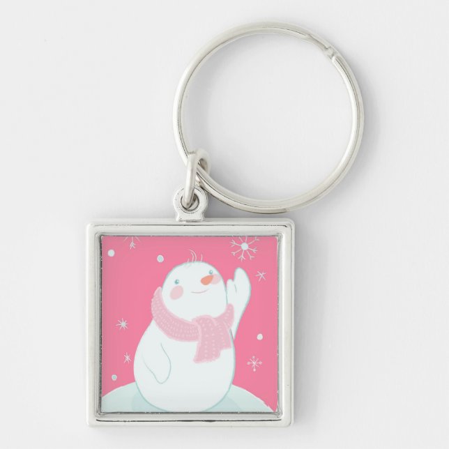 A snowman reaching for a falling snowflake keychain (Front)
