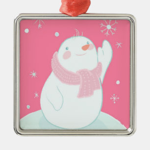 A snowman reaching for a falling snowflake metal ornament