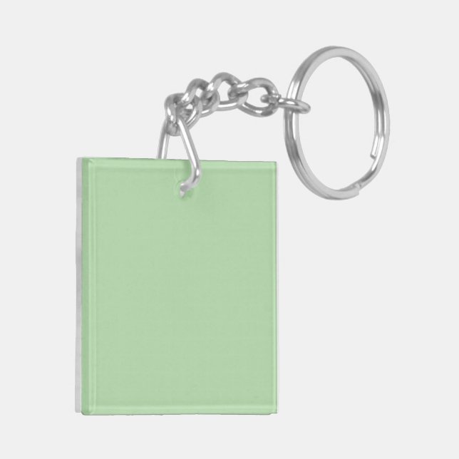 A soft pale green background fills the image keychain (Back Left)