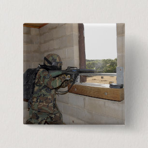 A soldier acts as an opposition force 2 inch square button