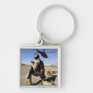 A soldier conducts security for an HH-60 Keychain