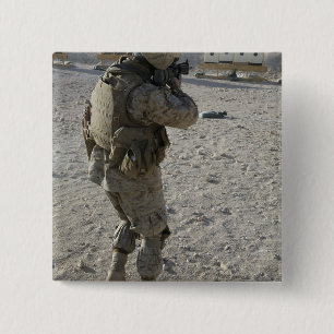 A soldier engages his target on a shooting rang 2 inch square button