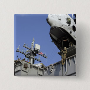 A soldier fast-ropes 2 inch square button