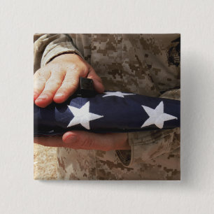 A soldier holds the United States flag 2 Inch Square Button