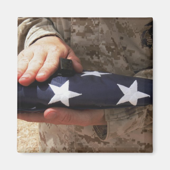 A soldier holds the United States flag Magnet (Front)