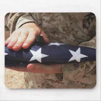 A soldier holds the United States flag Mouse Pad
