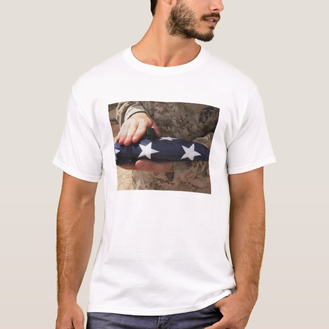 A soldier holds the United States flag T-Shirt (Front)
