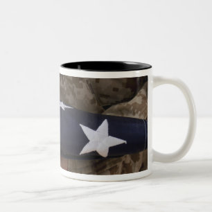 A soldier holds the United States flag Two-Tone Coffee Mug