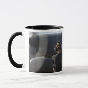 A soldier monitors the performance mug