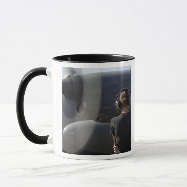 A soldier monitors the performance mug (Left)