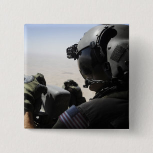 A soldier provides security 2 inch square button