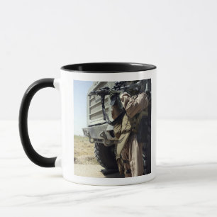 A soldier provides security for Marines Mug