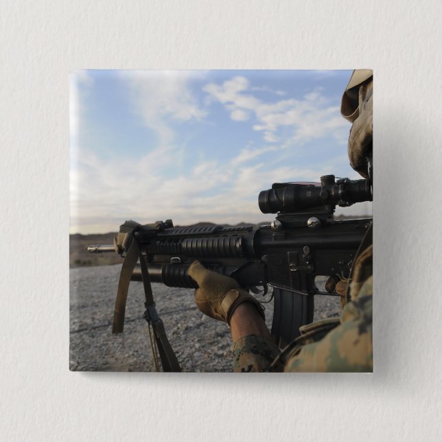A soldier sights in to fire on a target 2 inch square button (Front)