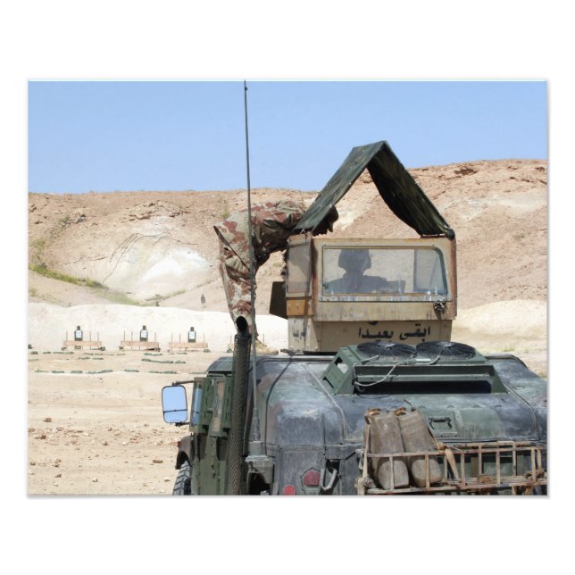 A soldiier instructs an Iraqi army soldier Photo Print (Front)