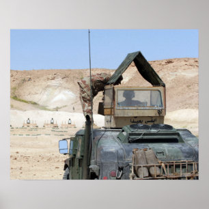 A soldiier instructs an Iraqi army soldier Poster