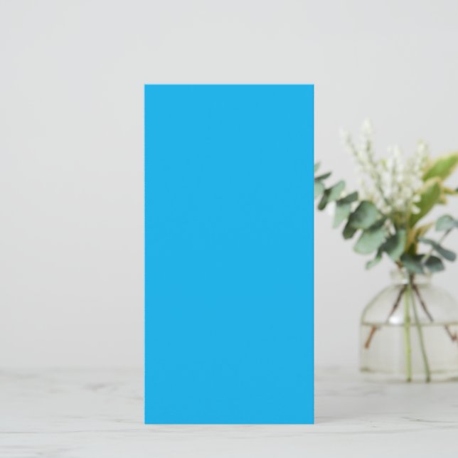 A solid bright blue background fills  card (Standing Front)