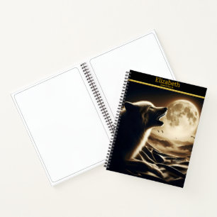 A solitary wolf's call beneath a radiant moon notebook