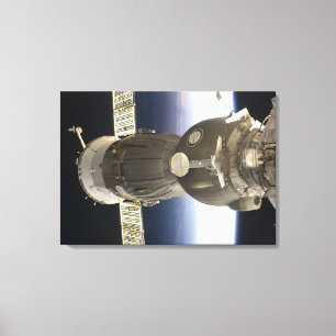 A Soyuz spacecraft backdropped by Earth Canvas Print