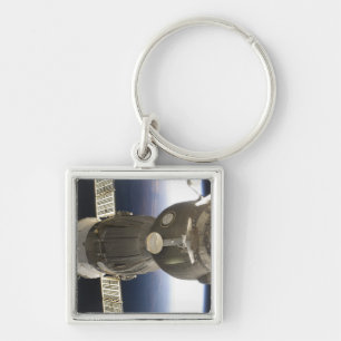 A Soyuz spacecraft backdropped by Earth Keychain