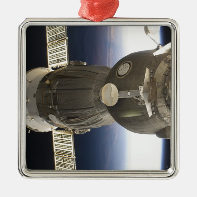 A Soyuz spacecraft backdropped by Earth Metal Ornament (Front)