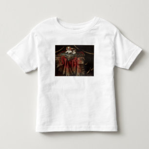 A spaniel seated on an embroidered cushion toddler t-shirt