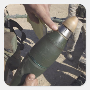 A squad leader points to a delay setting square sticker