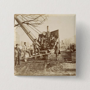 A steam crane in operation during the building of 2 inch square button