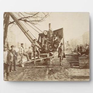 A steam crane in operation during the building of plaque