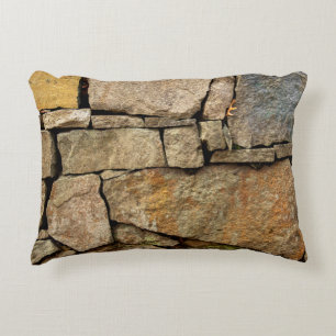 A stone wall made of cobblestones background textu accent pillow